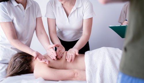 an instructor helping a student with a massage