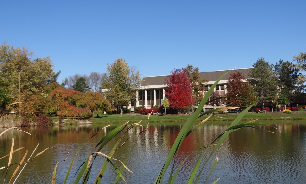 Northeast College campus with a pond in front of it