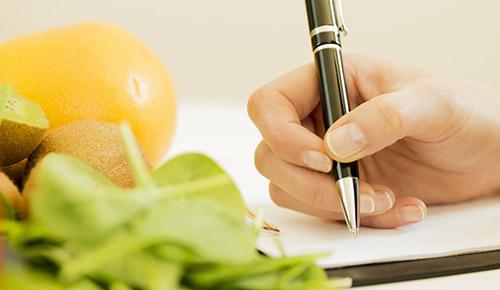 A person writing on a paper