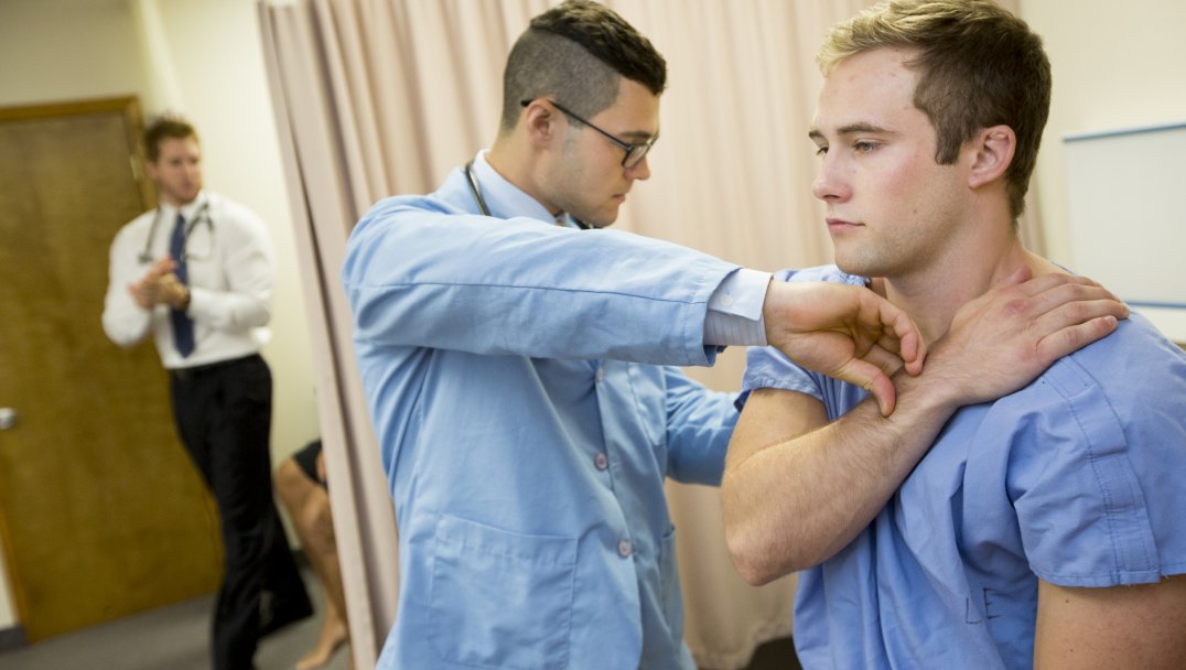 A student practicing chiropractic manipulation