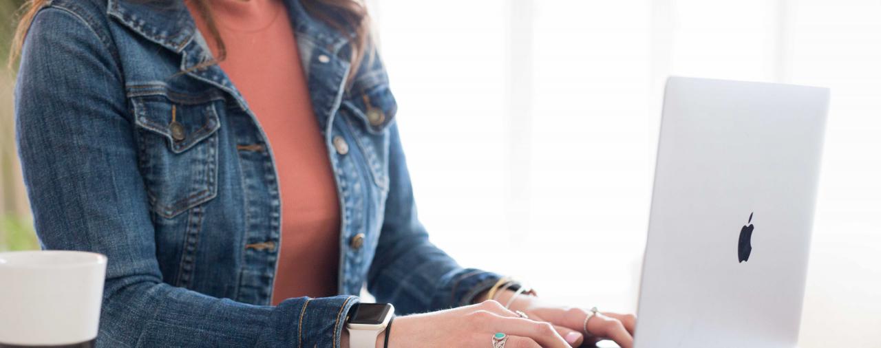A woman typing on a computer