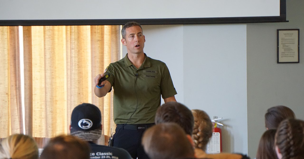 A person giving a lecture to students