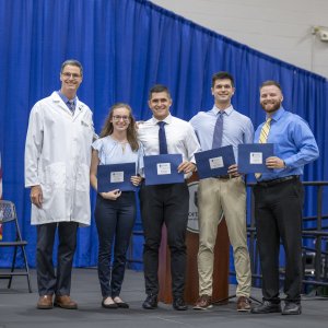 a group of students receive recognition