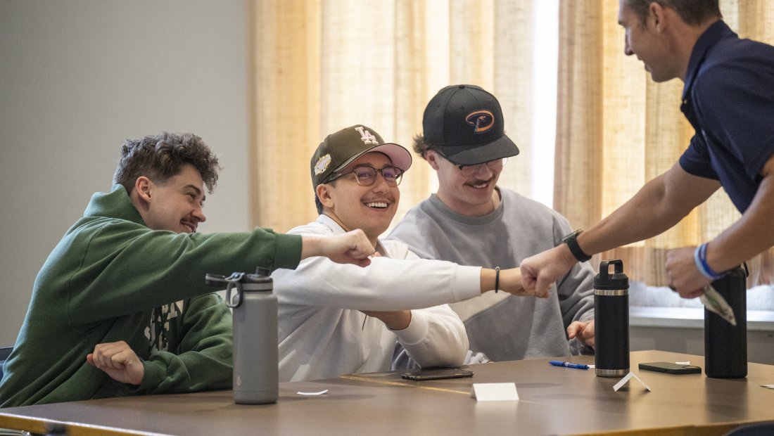 Dr. Kollmann fist bumping students