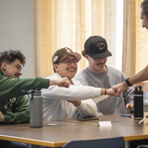 Dr. Kollmann fist bumping students