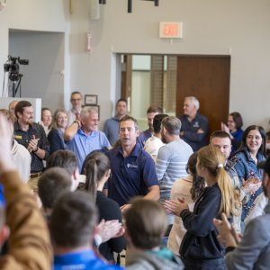 Dr. Kollmann moving through the crowd