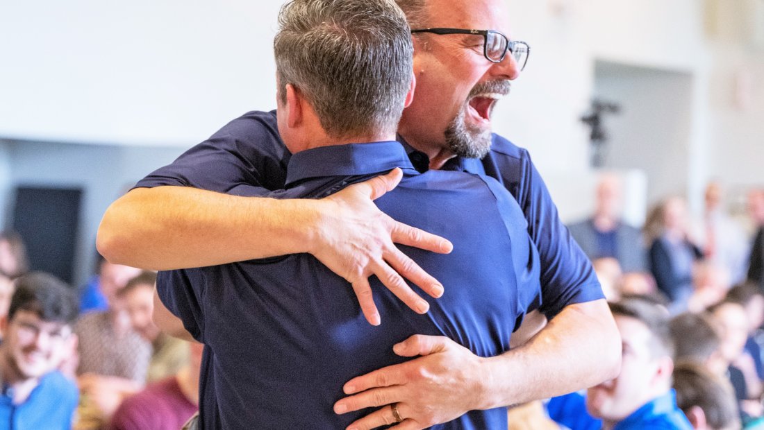 Dr. Kollmann giving President Mestan a hug