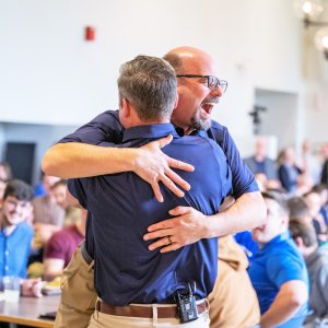 Dr. Kollmann giving President Mestan a hug