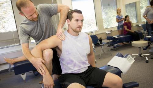 Students practicing chiropractic techniques