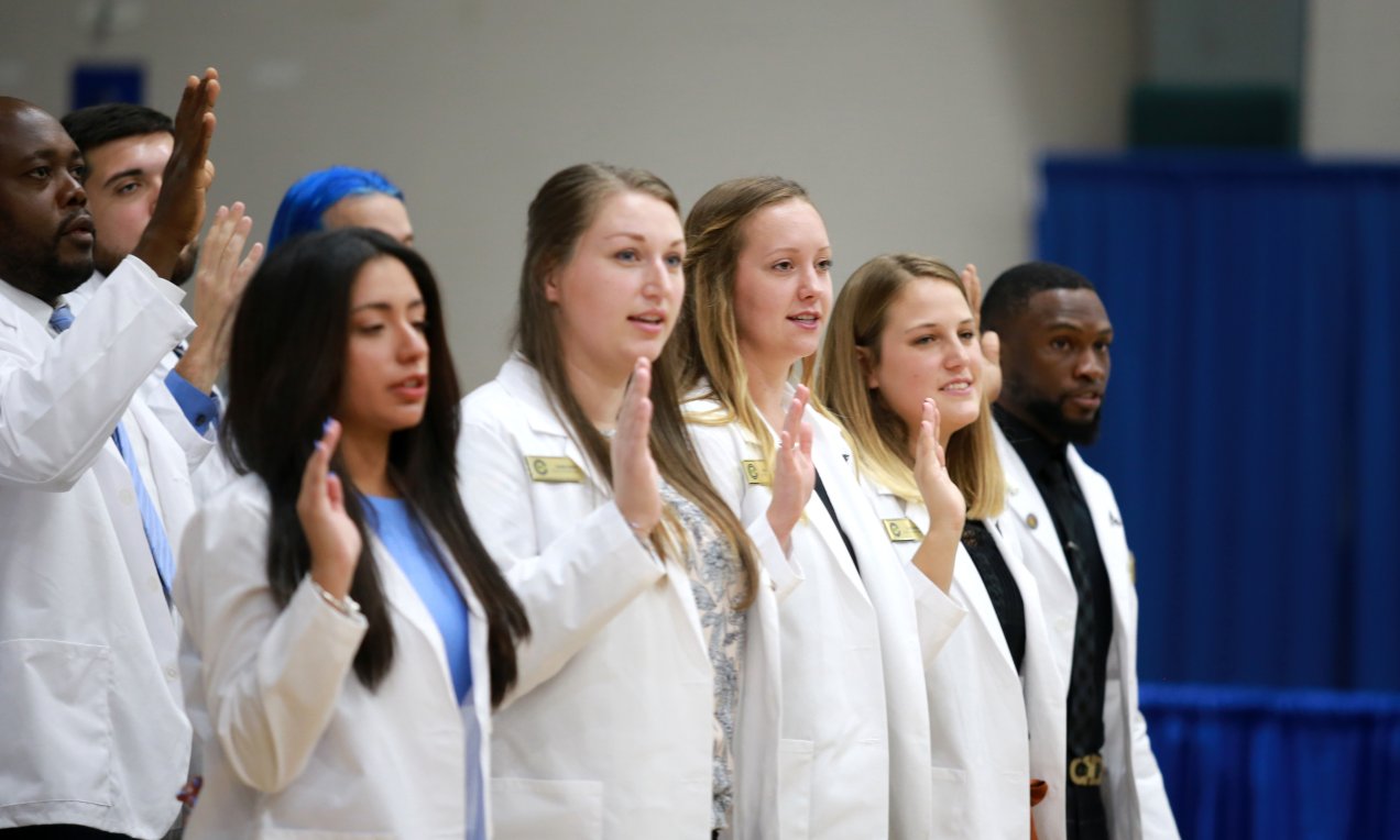 A group of students reciting the chiropractic oath