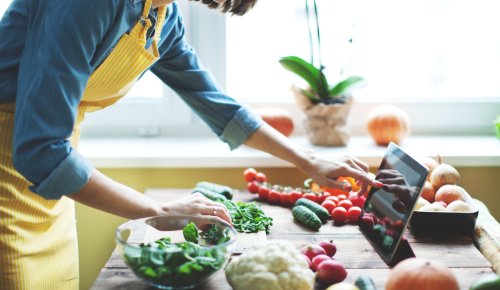 A nutritionist working on a tablet