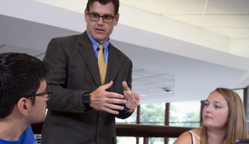 Students talking to a professor outside of class