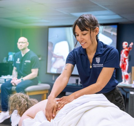 massage therapy student giving a massage in class