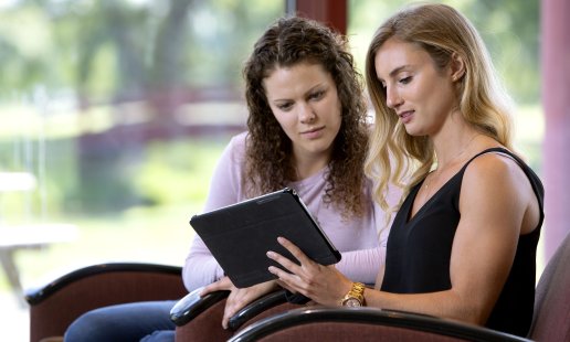 health science students looking at a tablet for a virtual open house