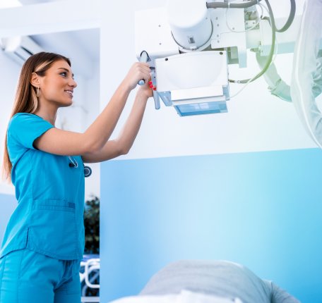 a radiologic technologist working with equipment