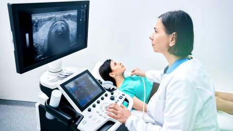a sonographer works with a pateint