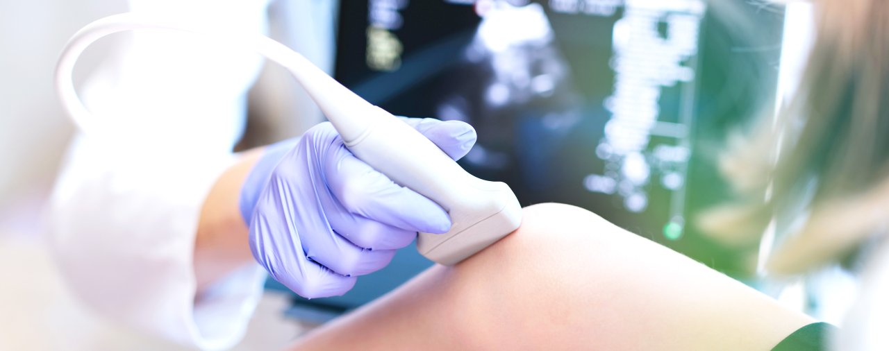 a diagnostic sonographer working with a patient