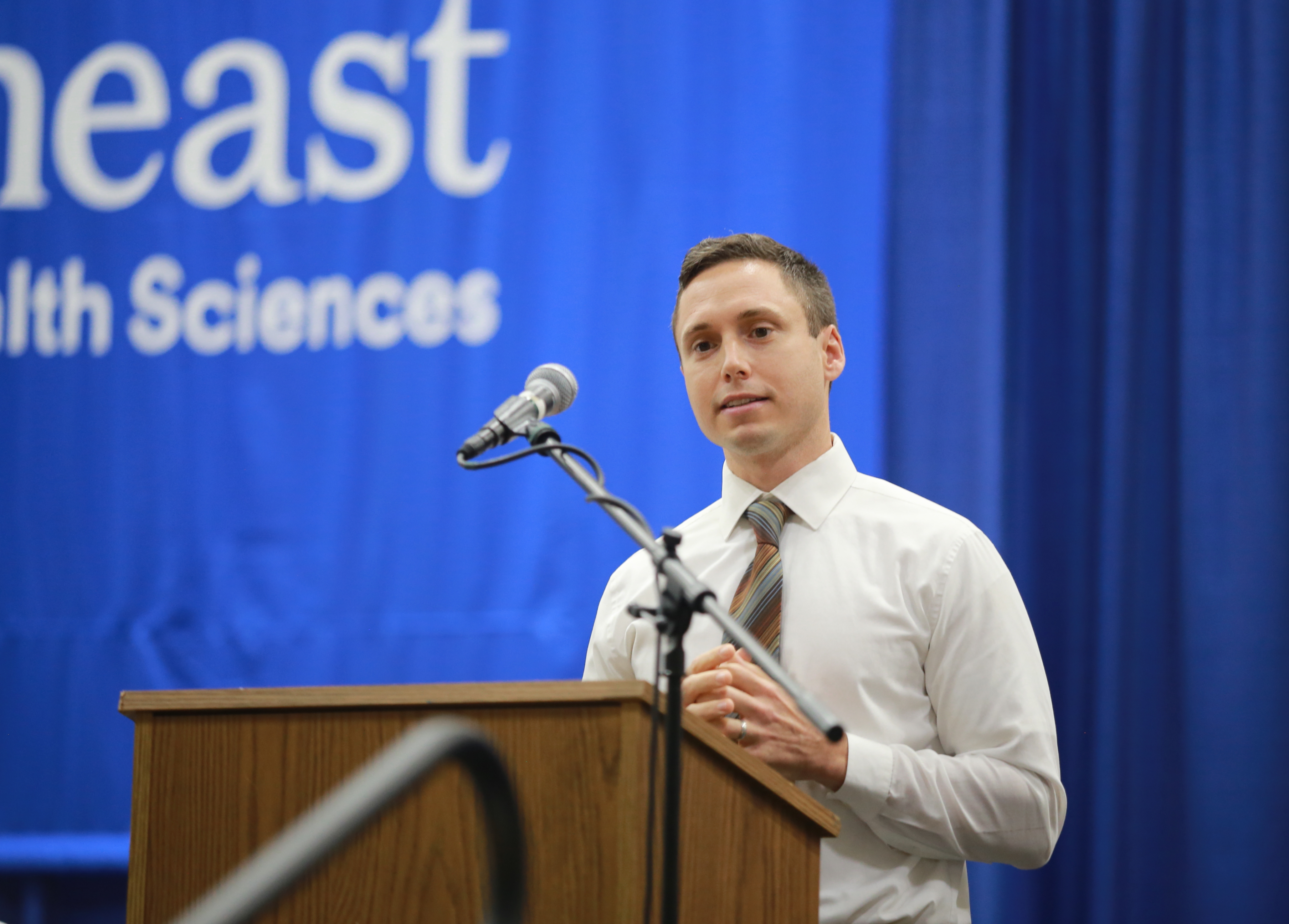 Dr. Barker speaking at a podium