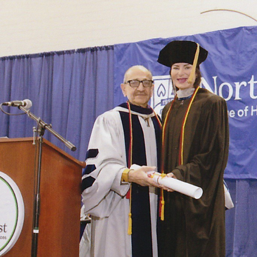 Dr. Hubley being recognized on stage at a commencement ceremony