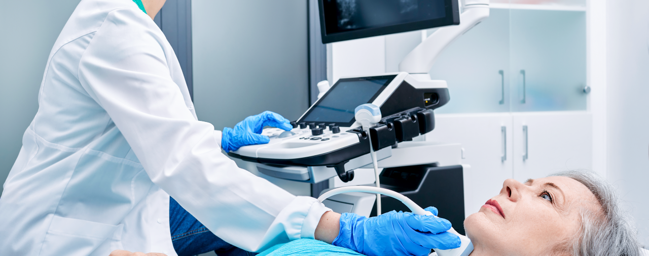 a sonographer working with a patient