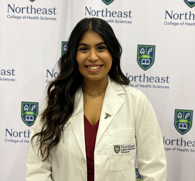 Jenna Patel posing in a clinical white coat